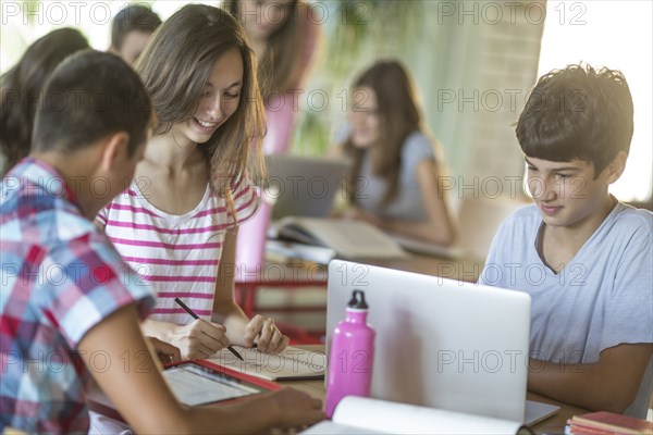 Students studying in school cafeteria