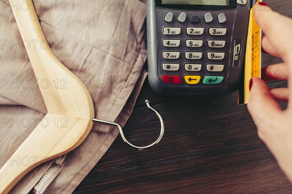 Woman swiping credit card through credit card reader