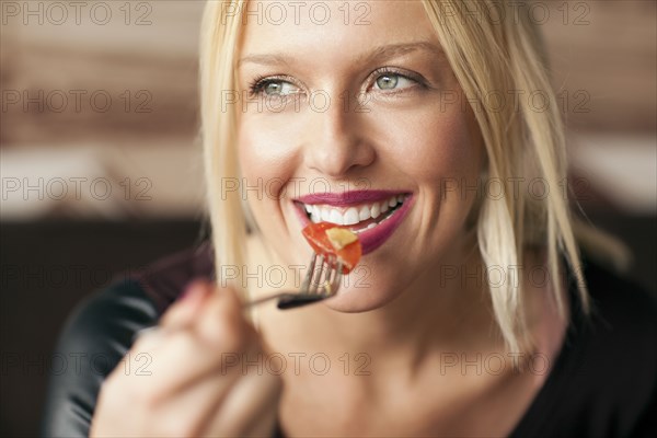 Woman eating food in cafe