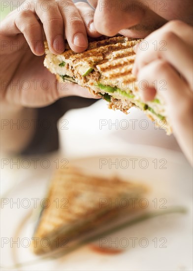Close up of woman eating sandwich