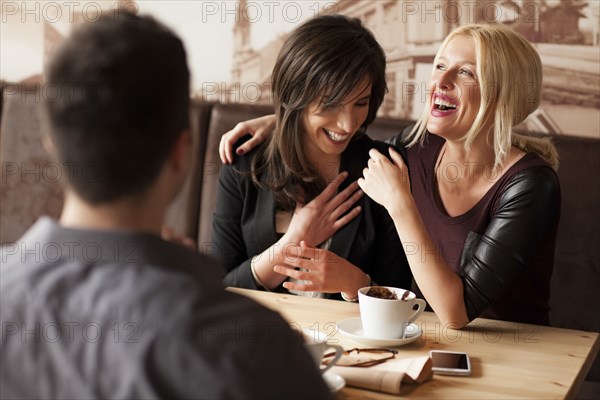 Women laughing in cafe