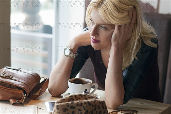 Woman sitting alone in cafe