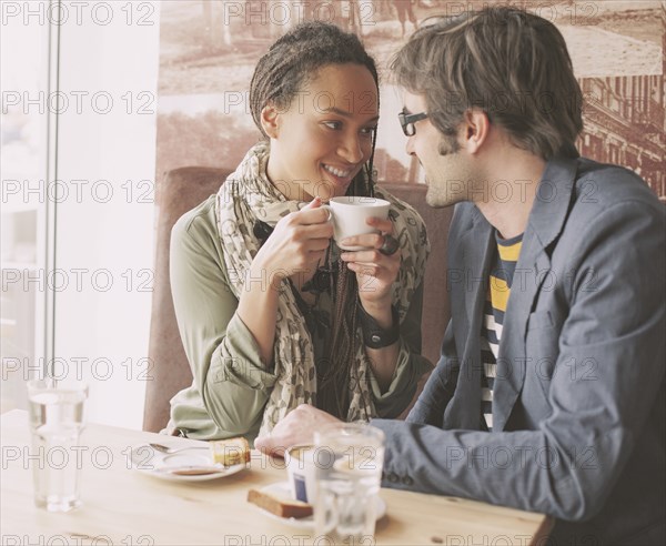 Couple drinking coffee in cafe