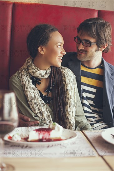 Couple eating dessert in cafe