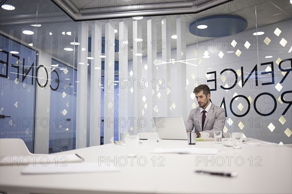 Caucasian businessman working in conference room