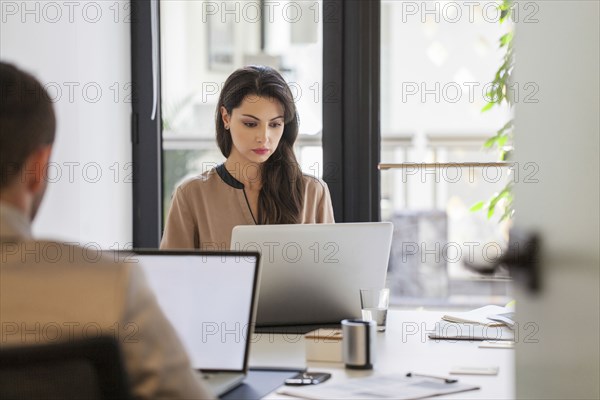 Caucasian business people working at desks in office