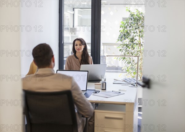 Caucasian business people working at desks in office