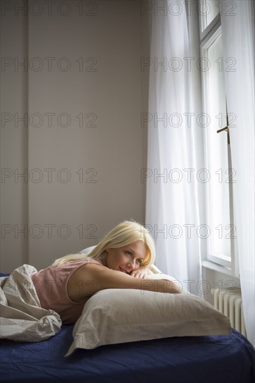 Smiling woman laying in bed