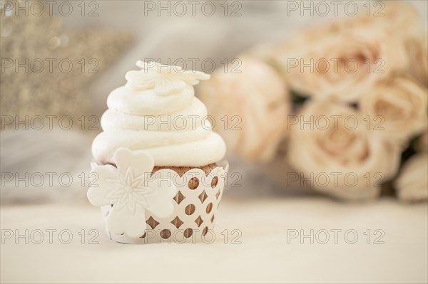 Close up of decorated cupcake with white icing