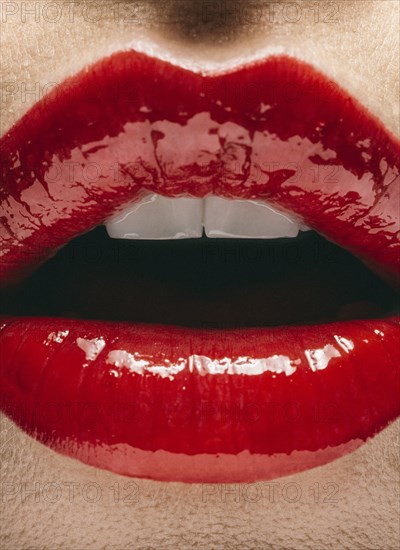 Close up of mouth of woman wearing red lipstick