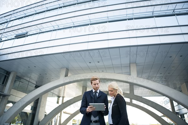 Business people using digital tablet outside outdoors