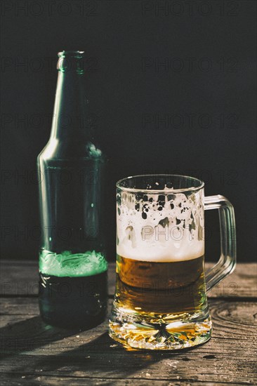 Glass and bottle of beer on table