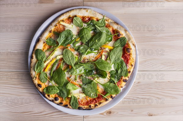 Close up of pizza with fresh spinach