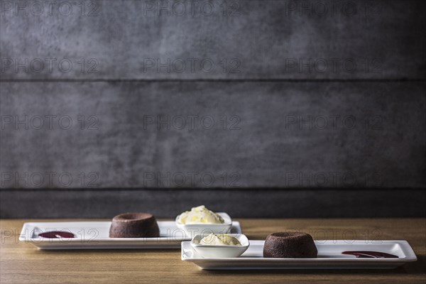 Platters of chocolate souffle dessert with ice cream and sauce