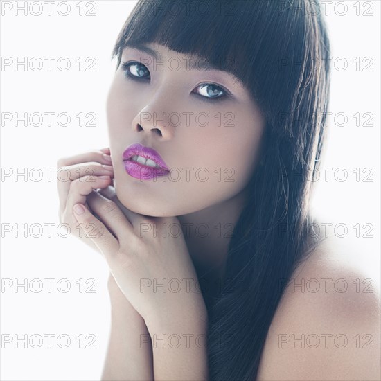 Close up of glamorous woman with hands on chin