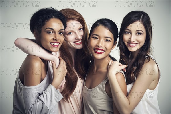 Close up of smiling women hugging