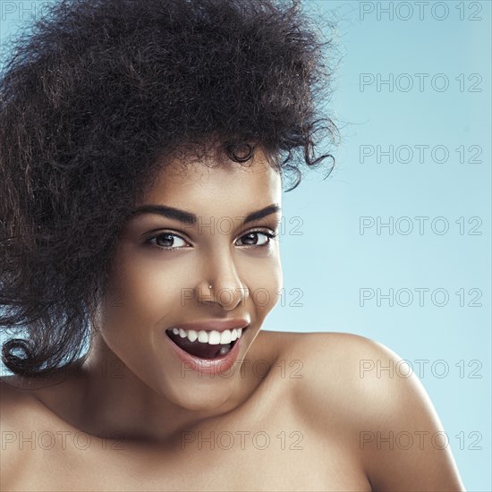 Close up of surprised woman with curly hair