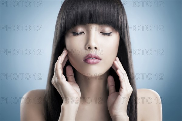 Close up of tranquil woman rubbing her face