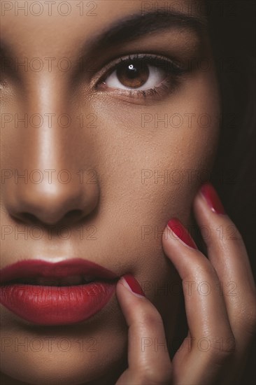 Close up of glamorous woman touching her face