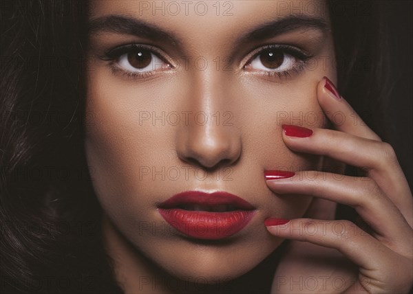 Close up of glamorous woman touching her face