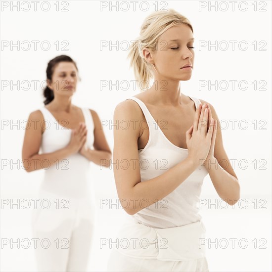 Close up of women meditating in yoga class