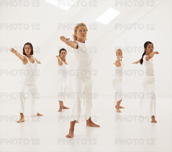 Women practicing yoga in class