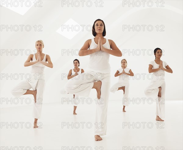 Women practicing yoga in class