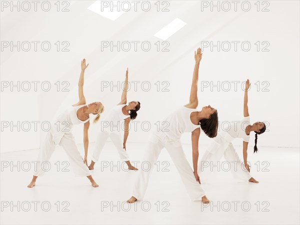 Women practicing yoga in class