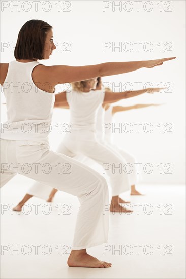 Women practicing yoga in class