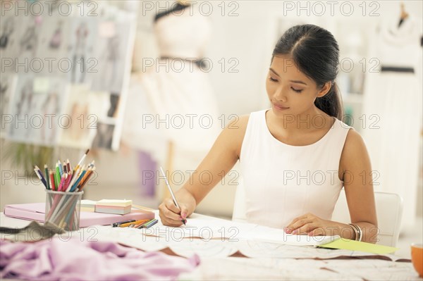 Fashion designer drawing in studio