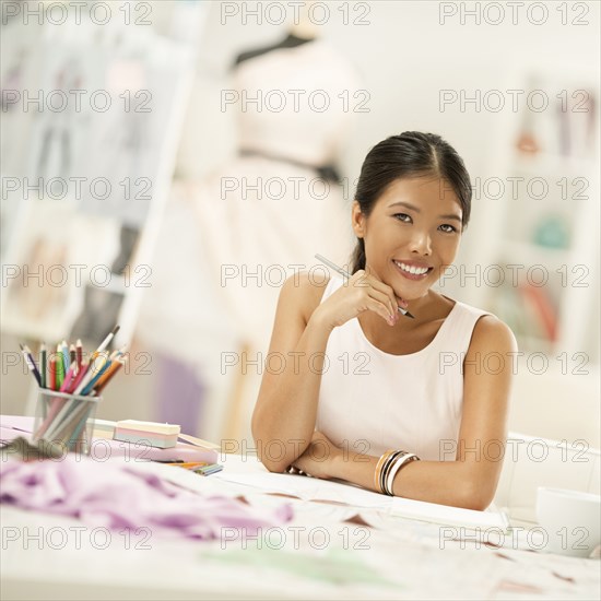 Fashion designer drawing in studio