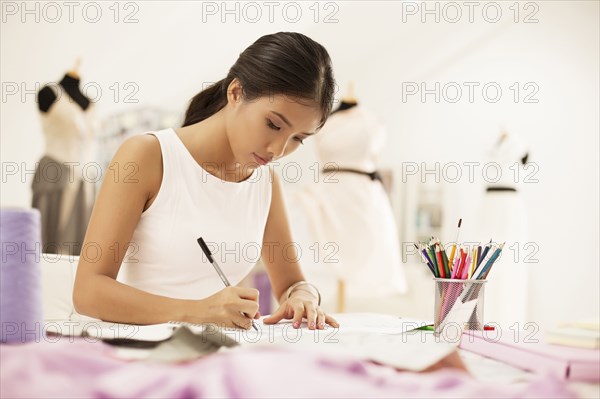 Fashion designer drawing in studio