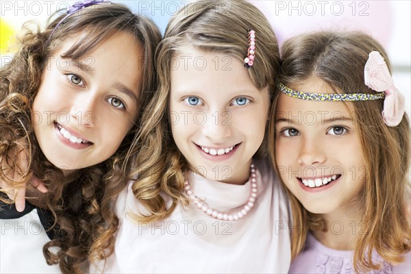 Close up of smiling girls hugging