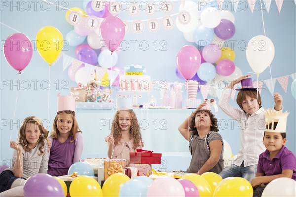 Children wearing hats at birthday party