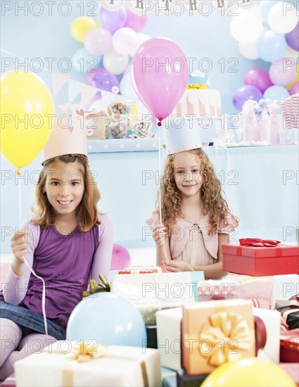 Girls holding balloons at birthday party