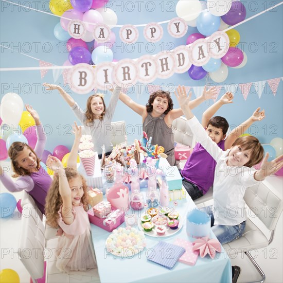 Children cheering at birthday party