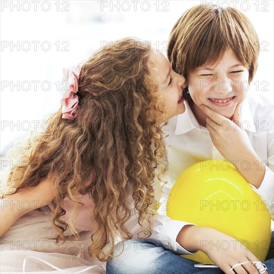 Close up of laughing children whispering