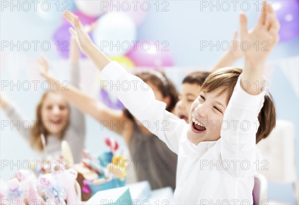 Children cheering at birthday party