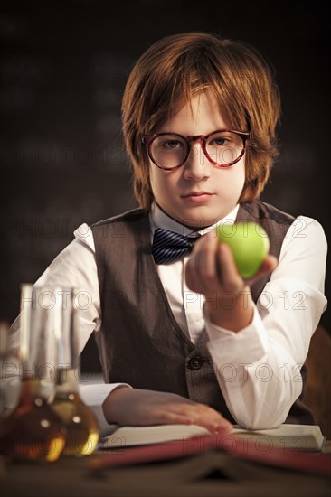 Student holding apple and studying