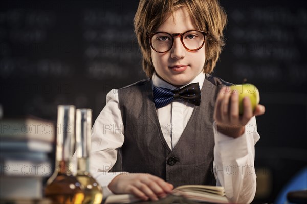 Student holding apple and studying