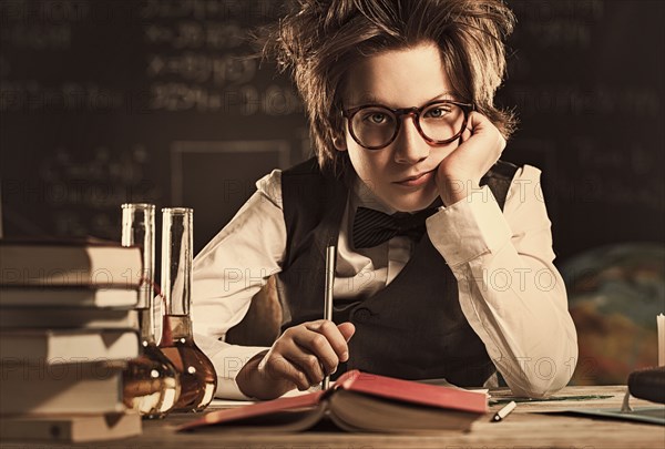 Bored student sitting at desk in classroom