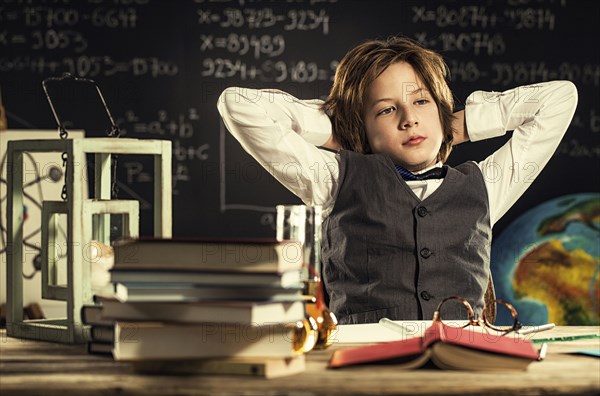 Bored student sitting at desk in classroom