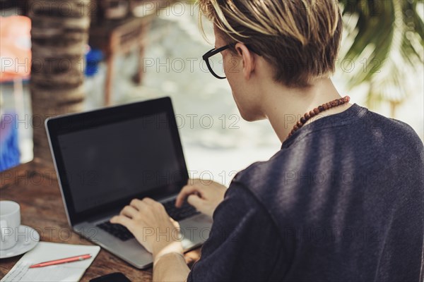 Caucasian man using laptop outdoors