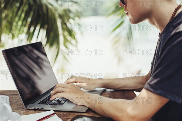 Caucasian man using laptop outdoors