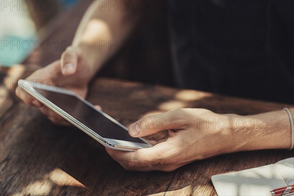 Caucasian man using cell phone at table