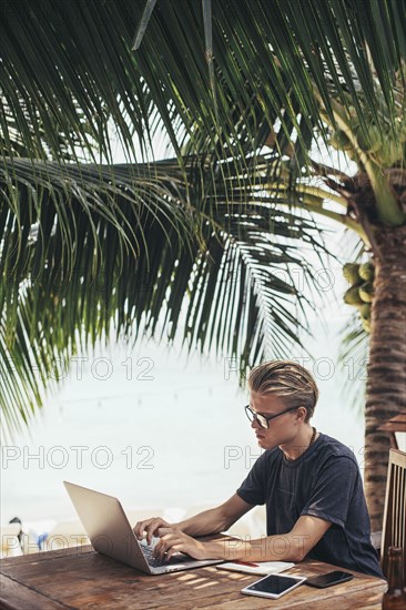 Caucasian man using laptop outdoors