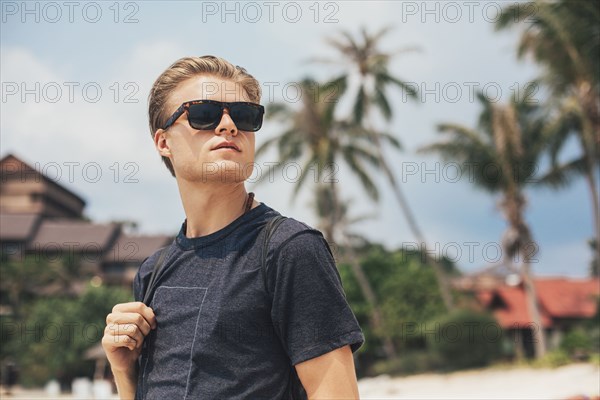 Caucasian man walking on beach