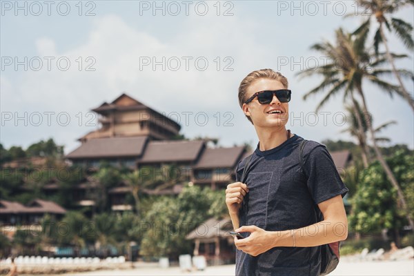 Caucasian man walking on beach