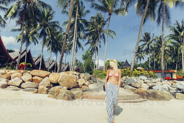 Caucasian woman walking on beach