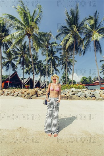 Caucasian woman walking on beach